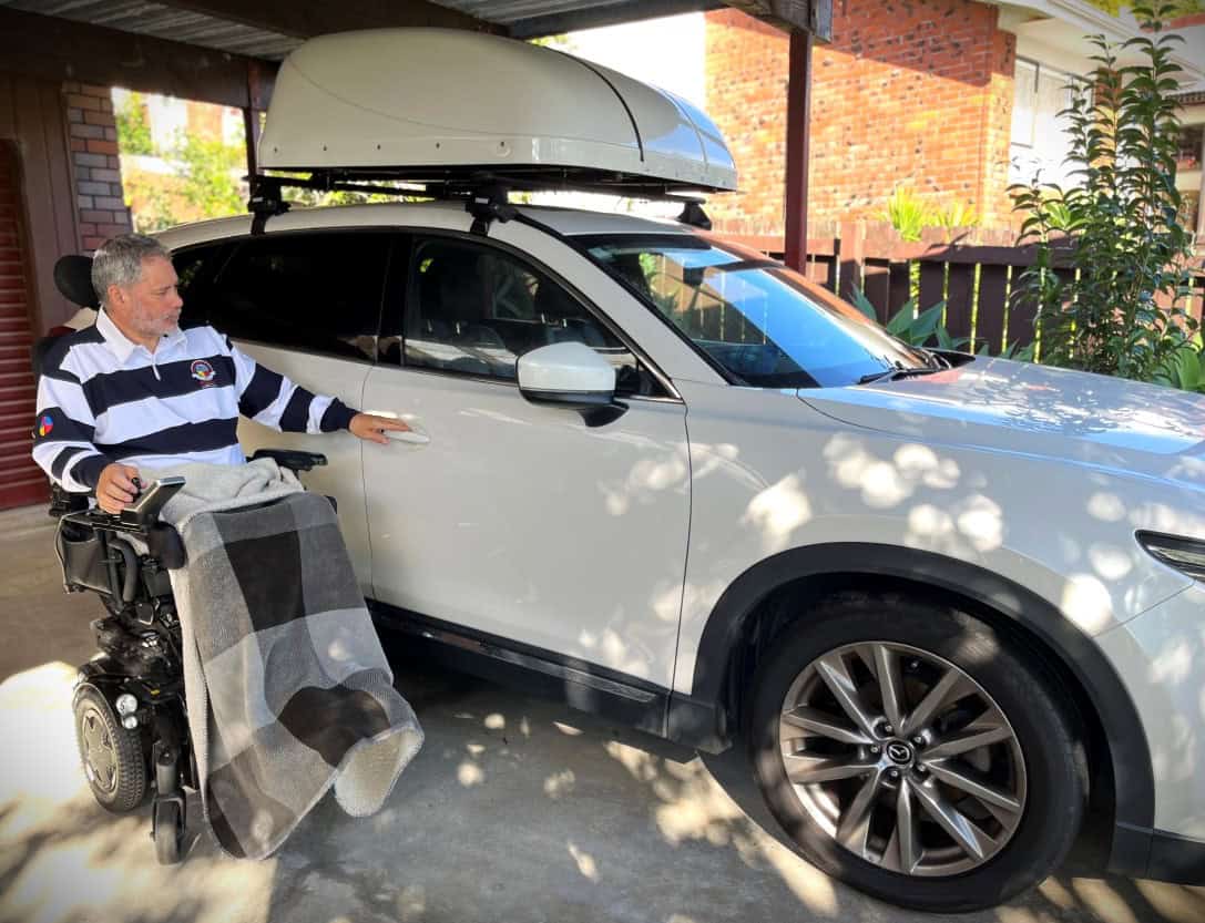 Mike alongside his modified Mazda CX-9, which gave him back independence and freedom after his MND diagnosis