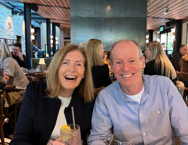 Robyn And Husband sitting side by side laughing