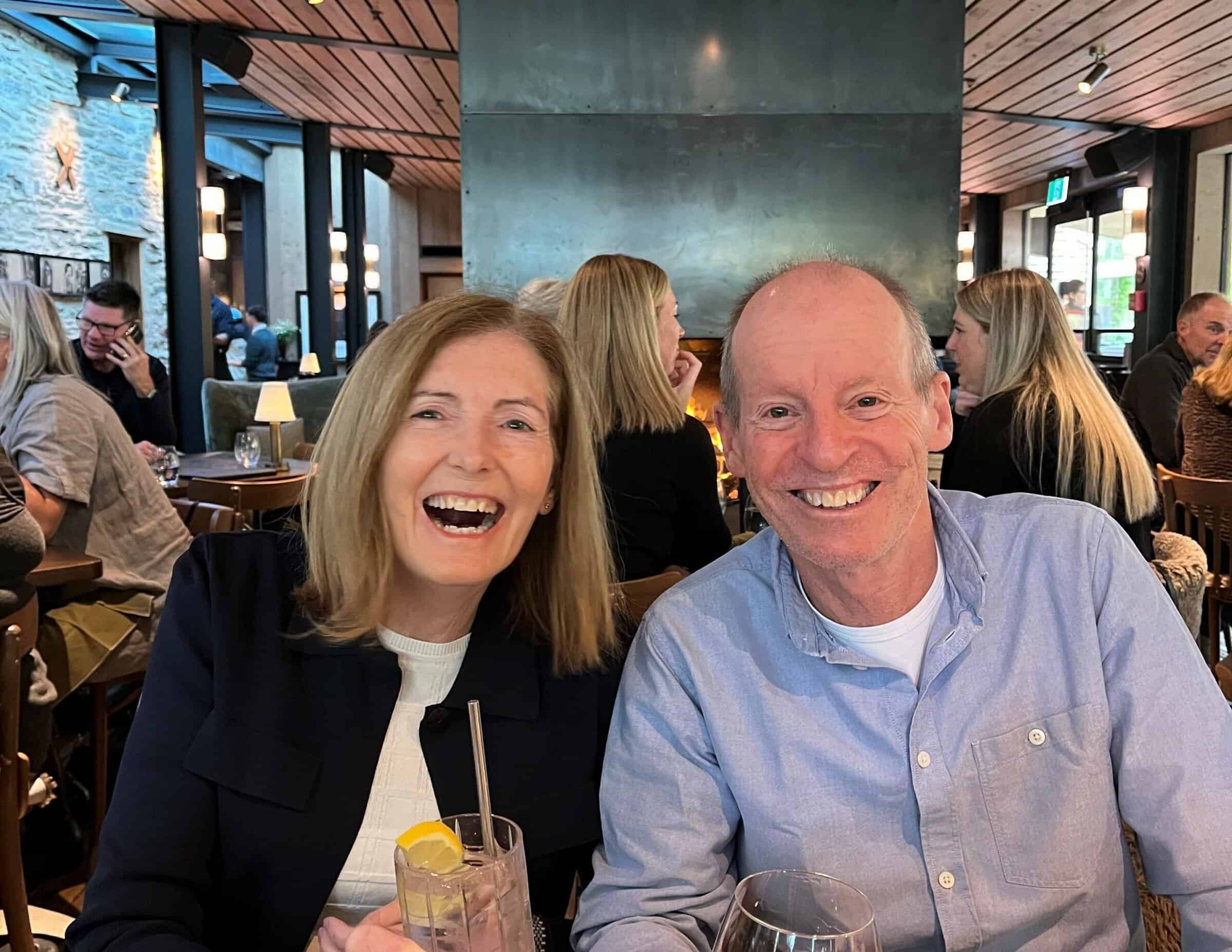 Robyn And Husband sitting side by side laughing