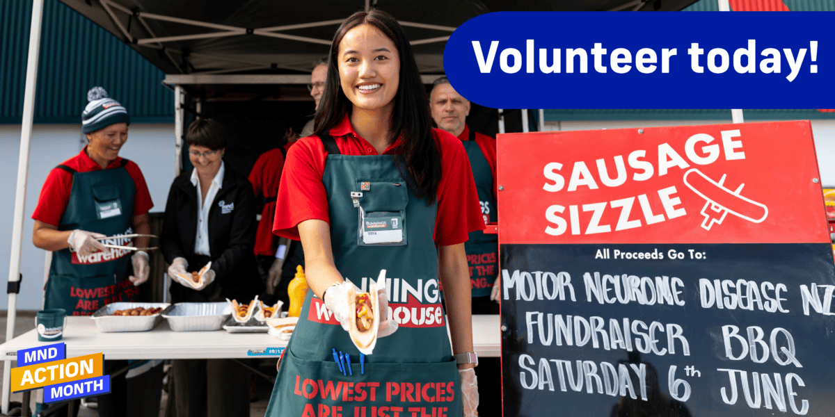 Bunnings staff working at a sausage sizzle to raise money