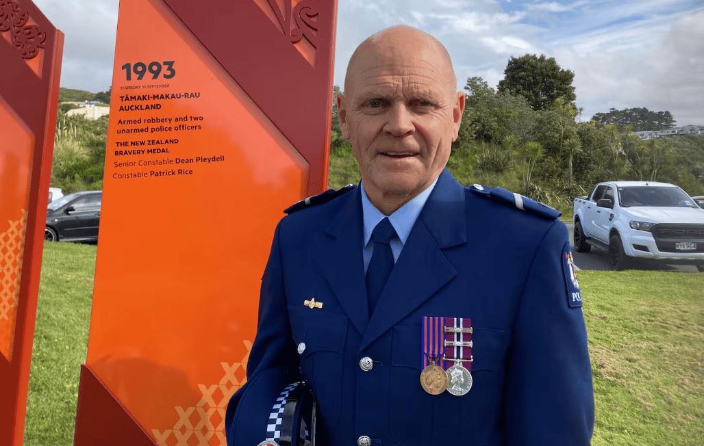 Senior Constable Stands Next To His Pou At Nz Police College Landscape